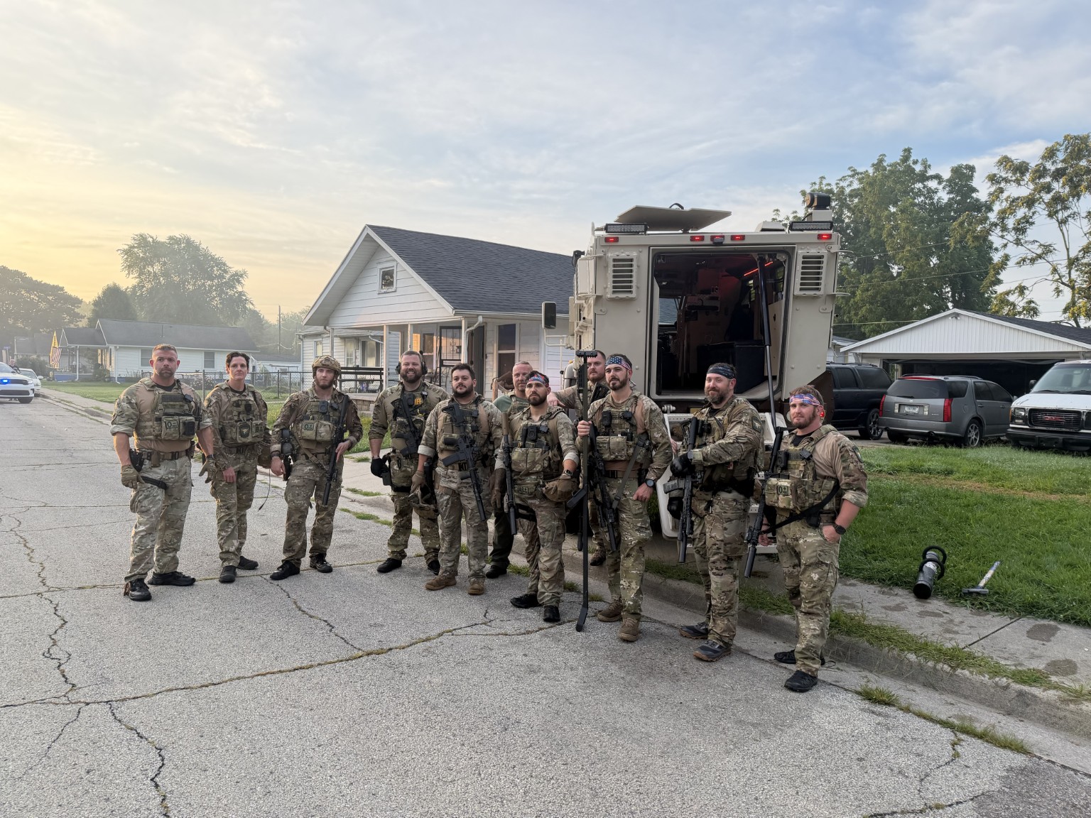 SWAT team members beside an armored vehicle
